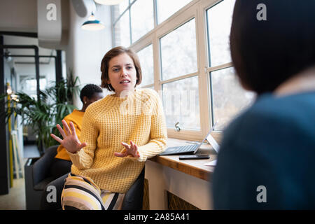 Unternehmerinnen im Gespräch im Büro Stockfoto