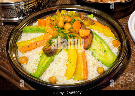 Marokkanisches couscous tajin auf geschnitzten, hölzernen Tisch. Stockfoto