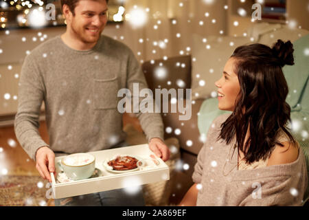 Glückliches Paar mit Essen auf Fach zu Hause Stockfoto