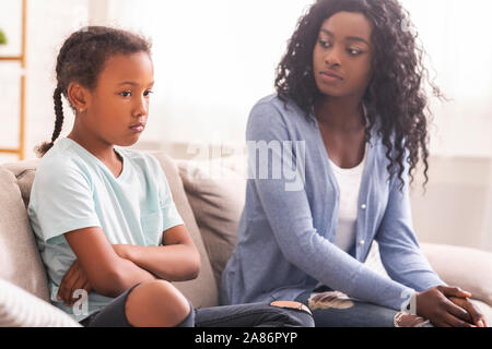 Enttäuscht schwarze Mutter mit ihrer kleinen Tochter mit Schande Stockfoto