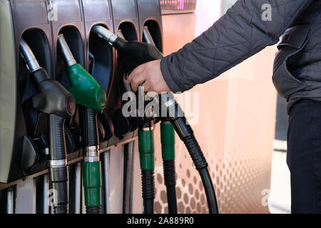 Man füllt sich sein Auto mit Benzin an der Tankstelle. Tankstelle Pumpe. Zu Auto mit Kraftstoff füllen. Benzin und Öl Produkte. Stockfoto