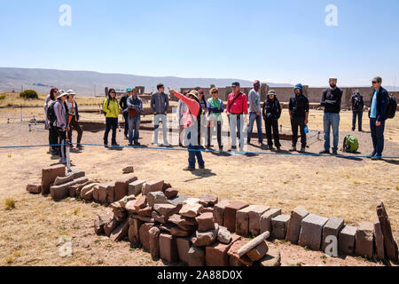 Gruppe von Besuchern hören zu den lokalen Guide in Tiwanaku archäologischen Komplex, Bolivien Stockfoto