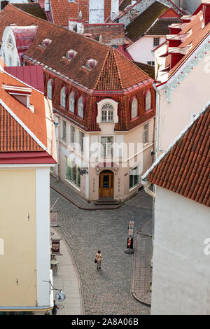 Ein einsamer Pendler nähert sich früh am Morgen einer Gabelung in der Straße. Stockfoto