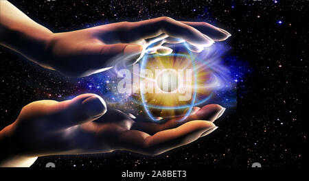 Person's Hände halten ein Atom Stockfoto