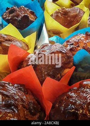 In der Nähe von paar leckere, frisch gebackene blueberry muffins. Bereit zu essen, süße glänzende Muffins werden in bunten hellen roten, blauen und gelben Pape gewickelt Stockfoto