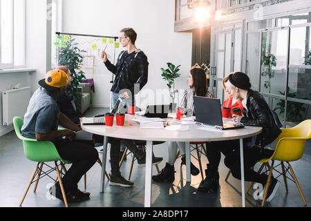 Gruppe von leger gekleidete Geschäftsleute Diskutieren von Ideen im Büro. Kreative Fachleute, die an der Konferenz Tisch für die Stockfoto