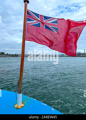 Red Ensign Fliegen in die Meeresbrise und Southampton Docks im Hintergrund. Stockfoto