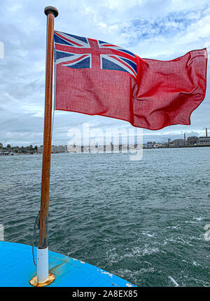 Red Ensign Fliegen in die Meeresbrise und Southampton Docks im Hintergrund. Stockfoto