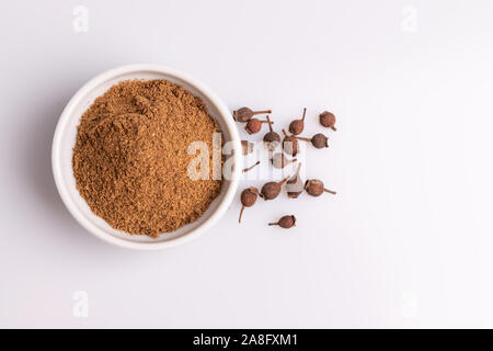 Boden Piment aus weisser Keramik Schüssel auf weißem Hintergrund, weiches Licht, studio Shot, kopieren. Auch Jamaika Pimenta, oder myrtle Peppe Stockfoto