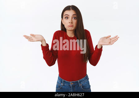 Betrübt und ratlos cute fragte brunette Mädchen im roten Pullover haben keine Ahnung, was passiert, die Hände seitlich und Geldbeutel Lippen, schütteln den Kopf Stockfoto