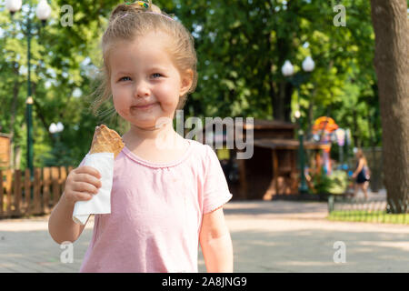 Kleines Mädchen mit einem Eis und Gesicht in der Schokolade Stockfoto