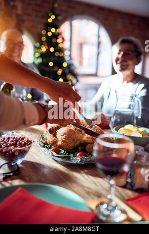 Familie und Freunde speisen zu Hause feiern Weihnachten mit traditionellem Essen und Dekoration, Vorbereitung der Türkei für das Abendessen Stockfoto