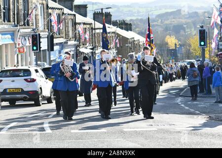 10. November 2019 neue Mühlen, Derbyshire. Eine Band führt die Erinnerung Tag der Parade auf der Union Street von St George's Parish Church in die Gedenkstätte in der Lea Park. Stockfoto