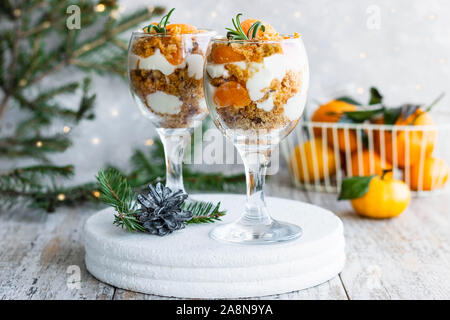 Citrus Kleinigkeit mit Karotte Keks und frische Mandarinen in einem Glas. Weihnachten portioniert Dessert auf der festlichen Tafel. Stockfoto