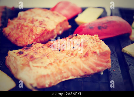 Lachssteaks auf Grill mit Gemüse gebraten, getönten Bild Stockfoto