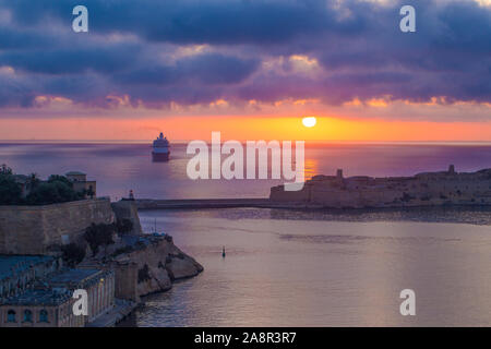 Valletta Hafen in farbenfrohen Sonnenaufgang mit Kreuzfahrtschiff, Malta Stockfoto