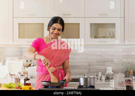 Frau Saree Kochen in der Küche Stockfoto