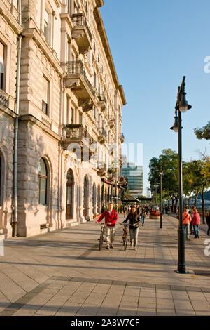Touristen und Einheimische zu Fuß in der Nähe von Hotels und Restaurants entlang der Donau Promenade von Budapest Stockfoto