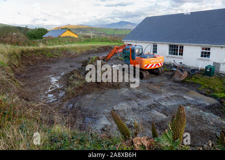 Aushub Boden an der Rückseite des privaten Haus mit Bulldozer, den Boden für die Entwässerung zu Ebene Stockfoto