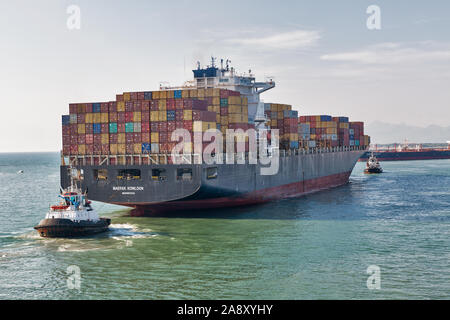 LIVORNO, ITALIEN - Juli 23, 2019: Schlepper und riesige Container Containerschiff Maersk Kowloon in Port. Maersk Line ist einer der weltweit größten dänischen international c Stockfoto