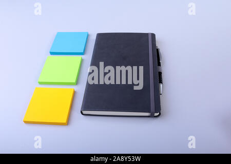 Blick von oben auf die leere Notebook und leer Hinweis Aufkleber auf einem blauen Hintergrund. Zurück zum Konzept der Schule. Flach Stockfoto