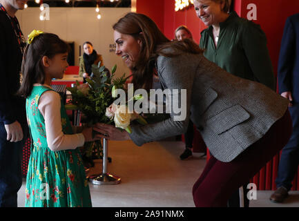 Die Herzogin von Cambridge ist mit Blumen von Michaela Conway vorgestellt, acht aus Eltham gealtert, während eine freiwillige Veranstaltung mit der Charity Anschreien, der Troubadour Weiße Stadt Theater in London. Stockfoto