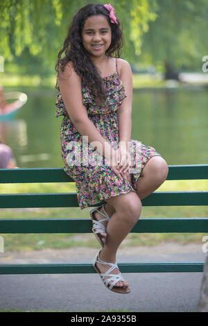 Portrait von hispanischen Teenager-Mädchen mit Zahnspangen sitzen in der parken Stockfoto