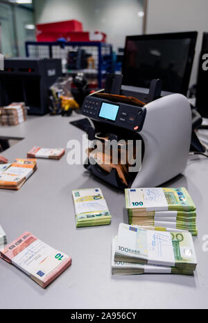 Euro €-Banknoten gestapelt und zusammen mit Währung Bands vor der elektronischen Zählmaschine gebunden Stockfoto