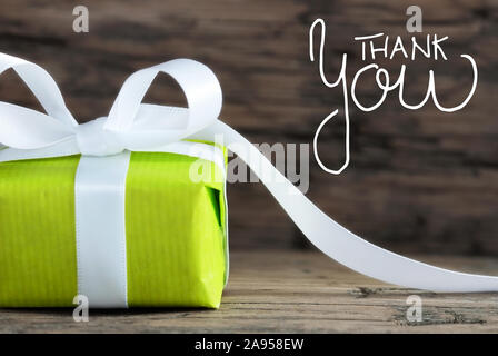 Eine grüne Geschenk, Weiß Bogen, Holz- Hintergrund, Danke Stockfoto
