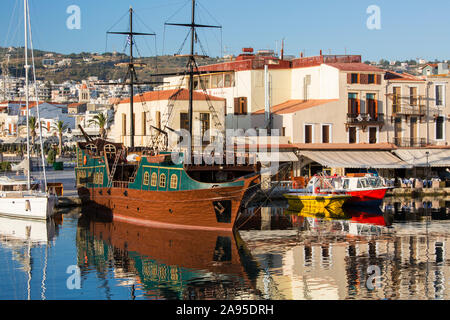 Rethymno, Kreta, Griechenland. Blick über den venezianischen Hafen, am frühen Morgen, bunte Boote in stillem Wasser reflektiert.