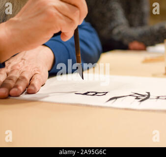 Kalligraphie Meister Zeichnung chinesische Hieroglyphe mit einer Bürste Stockfoto