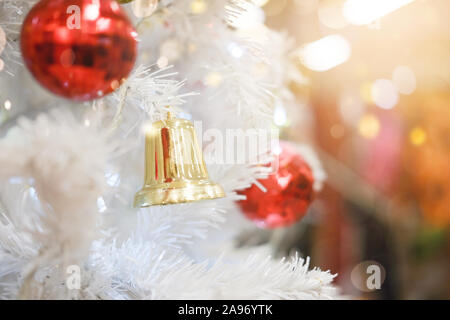 Feiertage und weihnachten im Hintergrund. Glänzende weihnachtskugel hängt an Kiefernzweigen. Stockfoto