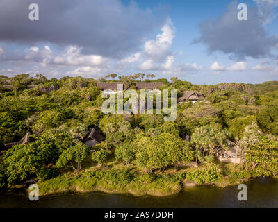 Traditionelle Lodge in einem küstennahen Wald durch eine Lagune am Indischen Ozean, Tansania. Stockfoto