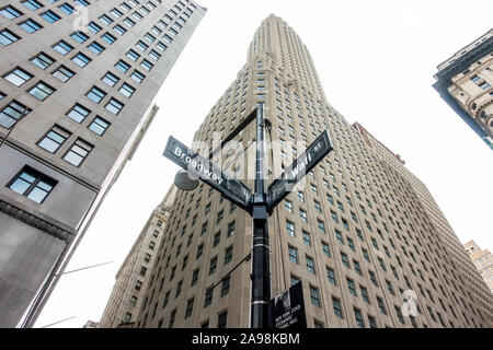 Wall Street und Broadway Straßenschilder mit Wolkenkratzern im Hintergrund Stockfoto