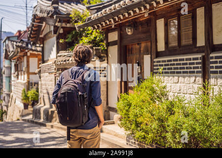 Junger Mann Tourist in das Dorf Bukchon Hanok ist einer der berühmten Platz für koreanische traditionelle Häuser erhalten geblieben sind. Reisen nach Korea Konzept Stockfoto