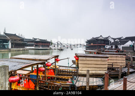 Holz- Touristen Boote Parkplatz am Kanal Fluss in Zhujiajiao in einer regnerischen Tag, eine alte Wasser Stadt in Shanghai, während der Ming- und Quing-Dynastien errichtet Stockfoto