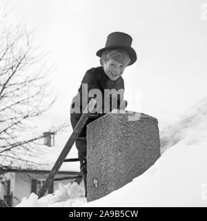 Ein kleiner Junge spielt die Schornsteinfeger als Symbol für Glück für das neue Jahr, Deutschland 1955 Stockfoto