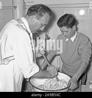 Hausfrauen in Panik: Vater und Sohn einen Nudelsalat, Deutschland 1958 Stockfoto