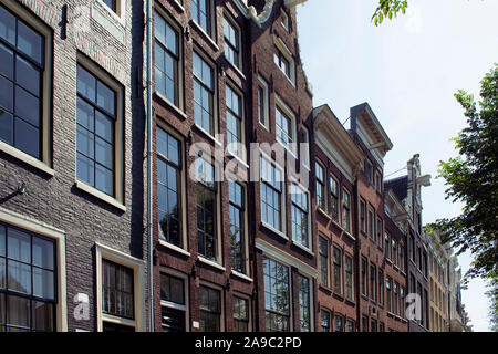 Blick auf die historische, traditionelle und typische Gebäude zeigen niederländische Architektur in Amsterdam. Es ist ein sonniger Sommertag. Stockfoto