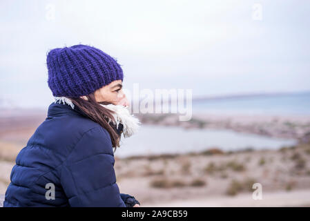 Seitenansicht einer Frau in der Wolle hat den Horizont auf der Suche Stockfoto