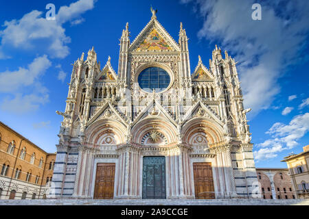 Der Dom von Siena ist eine Italienische romanisch-gotische Kathedrale mit einer beeindruckenden Fassade ist mit Skulpturen und architektonische Details, Toskana, Italien überfüllt Stockfoto