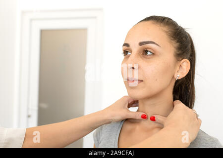Porträt eines Mädchens durch einen Arzt für Allgemeinmedizin untersucht, Kontrolle der Schilddrüse. Stockfoto