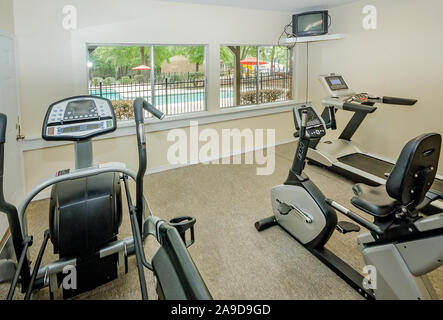 Das Fitnesscenter bietet Laufbänder, Fahrräder und andere Maschinen im Herbst Wald Apartments auf Foreman Road in Mobile, Alabama. Stockfoto