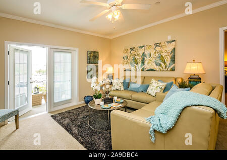 Das Wohnzimmer verfügt über französische Türen, die auf dem Balkon oder der Terrasse am Cypress Cove Apartment Wohnungen in Mobile, Alabama. Stockfoto