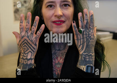 Berlin, Deutschland. 14 Nov, 2019. Netti Duden, Shop Manager in einem tattoo studio in Prenzlauer Berg, steht im Foyer des Studio. Sie trägt auch eine Trauer Tattoo, eine Zeichnung von ihr später Tomcat. Credit: Paul Zinken/dpa/Alamy leben Nachrichten Stockfoto