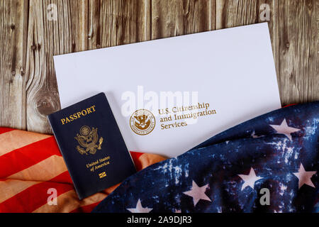 USA Reisepass und Staatsangehörigkeit Einbürgerung Zertifikat der US-Flagge über Holz- Hintergrund Stockfoto