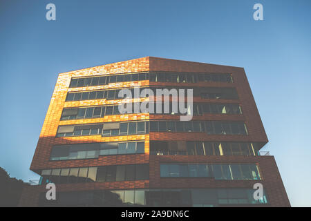 Ein großes Haus in Hamburg an der Elbe, deren Kupfer Fassade leuchtet im Sonnenuntergang Stockfoto