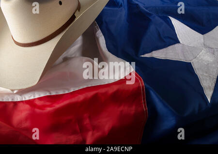 Cowboyhut und Stiefel sind ein Weg des Lebens in Texas durch ruht auf dem Lone Star State Flag. Stockfoto