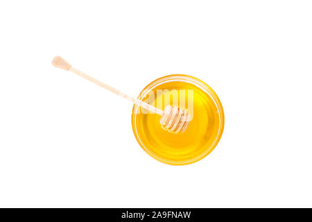 Pendelarm und Honig im Glas Schüssel auf weißem Hintergrund Stockfoto