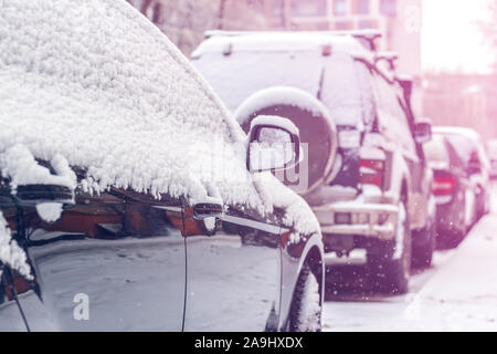 Schnee auf Autos nach Schneefall. Winter städtische Szene. Getönt Stockfoto